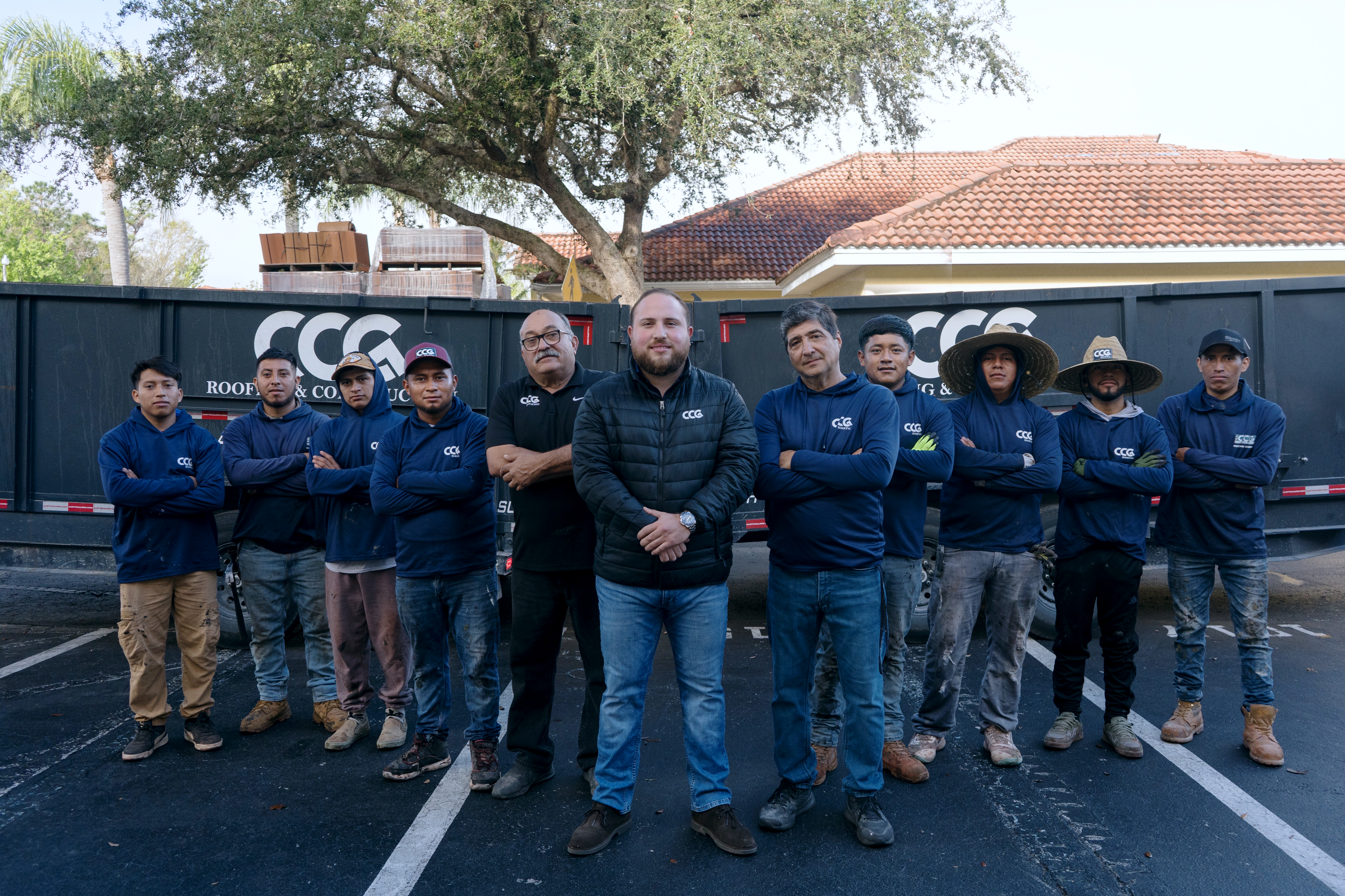 Caricare Group LLC roofing crew installing architectural shingles in Florida